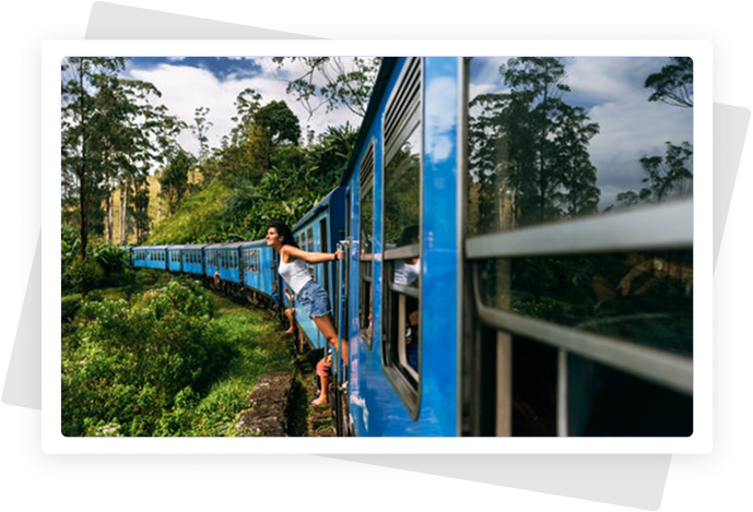 Blue train on bridge through mountains